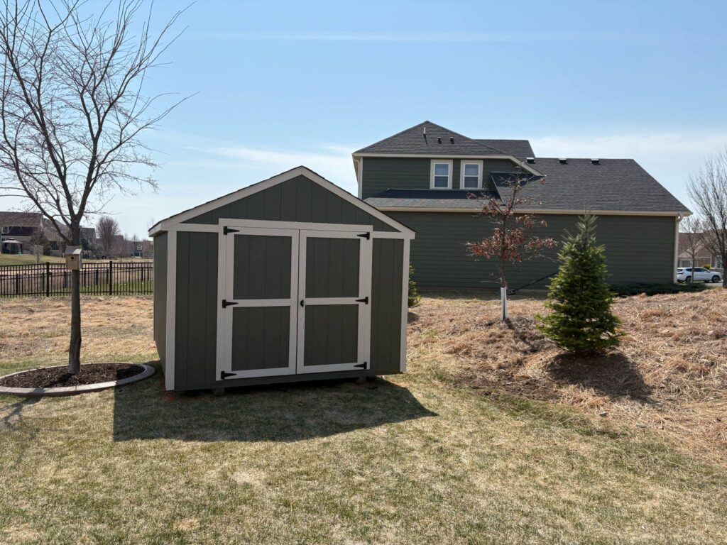 Rear angle of a 10x16 shed in Polk County, Wisconsin. Shed installed by Baldwin Shed Monkeys with elevated skids and ventilation detail.